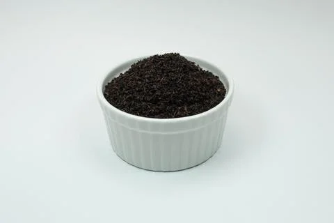 Tea leaves in a container with a white background Foto stock