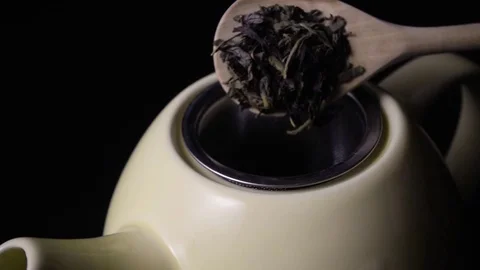 Tea leaves falls from the spoon super slow motion Stock Footage 72862832