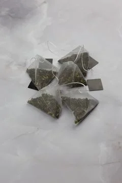 Tea leaves in the shape of nylon pyramids Stock Photos