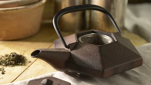 Tea leaves into teapot Stock Footage 77297554
