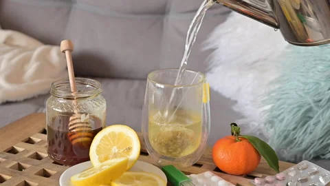 Tea with lemon and honey. Making a Hot Drink for Health in Fighting Viruses Stock Footage 149374424
