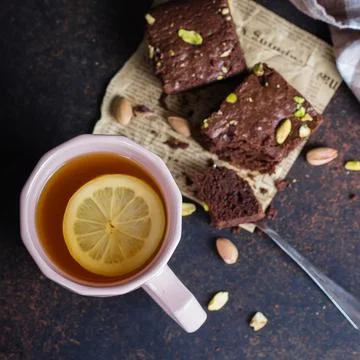 Tea with lemon and mint leaf with homemade biscuit brownie with pistachios .. Stock Photos