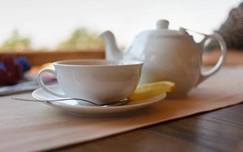 Tea with lemon and tea maker Tea with lemon and tea maker. Shallow depth o... Stock Photos
