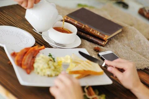 Tea with lemon on the background of breakfast Stock Photos