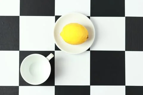 Tea with lemon on a chessboard. Stock Photos