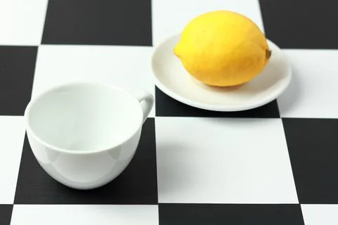 Tea with lemon on a chessboard. Stock Photos