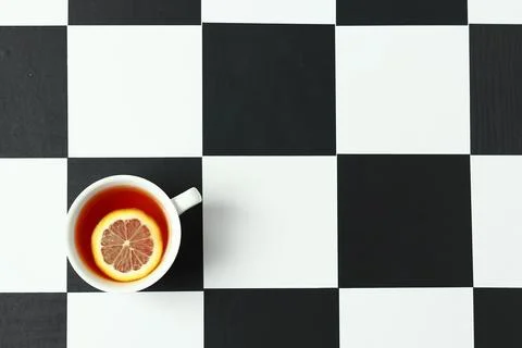 Tea with lemon on a chessboard. Stock Photos