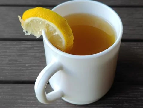Tea with lemon in a cup on the table Stock Photos