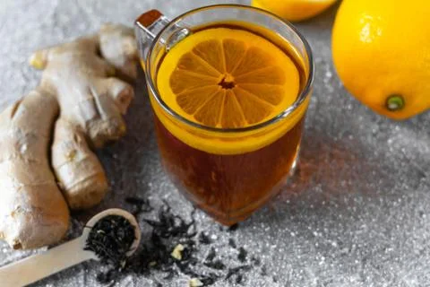 Tea with lemon, ginger root and teaspoon Stock Photos