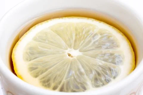 Tea with lemon in a mug on a white background close-up Foto stock