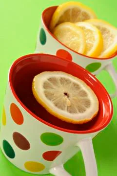 Tea with lemon in polka dot cups Stock Photos