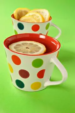 Tea with lemon in polka dot cups Stock Photos