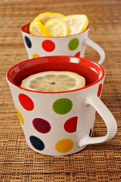 Tea with lemon in polka dot cups Stock Photos