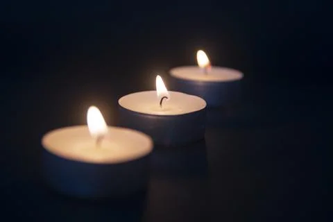 Tea light candle being lit by a woman with nice nails and a long match Stock Photos