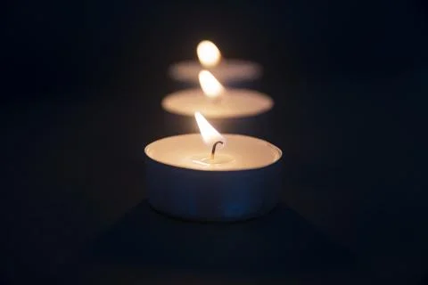 Tea light candle being lit by a woman with nice nails and a long match Stock Photos