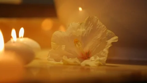 Tea lights with flickering flame in romantic spa lighting orchid B Stock Footage 120406913