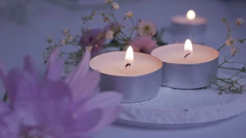  tea lights on a white stand. small candles. delicate white and pink flowers  Vídeos de archivo 260417820