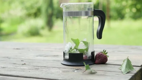 Tea made from herbs and berries is brewed in a transparent teapot on the 스톡 동영상 148431548