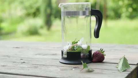 Tea made from herbs and berries is brewed in a transparent teapot on the Stock-Footage 148452261
