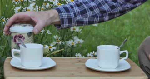 Tea. A man's hand pours tea from a tea bag into the cups 스톡 동영상 133145747