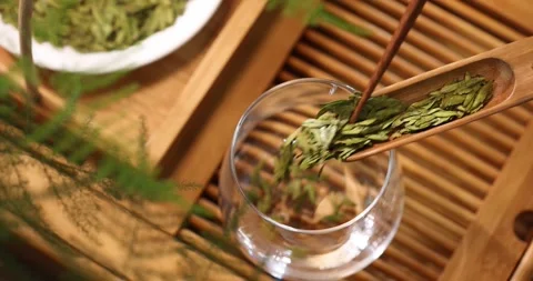 Tea Master Pouring Longjing Tea at Chinese Tea Table 4K Wide Shot Stock Footage 346472030