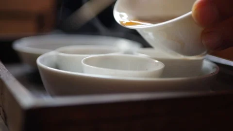 Tea master pours fermented green tea into tea cups for gaiwan or zhong Stock Footage 113401211