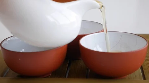 Tea master pours fermented green tea into tea cups. Element of traditional Stock Footage 127155406