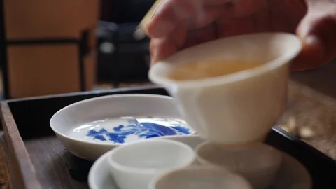 Tea master pours the green tea into tea cups for gaiwan or zhong. Traditional Stock-Footage 113534616