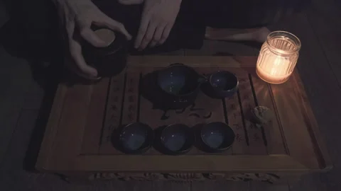 Tea master pours green tea in a circle into mug saturating the drink with oxygen Stock Footage 151185416