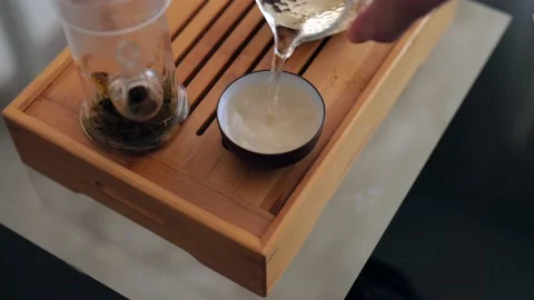 A tea master pours perfectly freshly brewed Chinese elite white tea Stock Footage 220342208