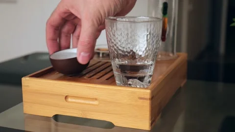 The tea master washes the tea utensils with boiling water Stock Footage 220341857