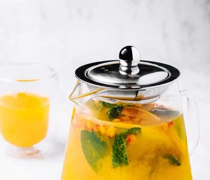 Tea with mint and orange. aromatic hot drink in glass jar. Stock Photos