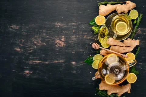 Tea with mint, ginger and lemon. Hot drink On a wooden background. Top view.  Stock Photos