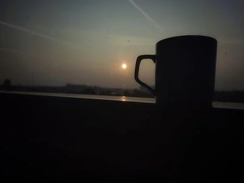 Tea or coffee cup shadow with sunlight background. Stock Photos