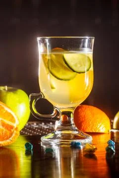 Tea or lemonade from apples, oranges and cucumbers in a glass Cup. Stock Photos