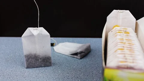 Tea packaging. Tea bag packaging on a black background. Assortment of tea bags. Stock Footage 195706554