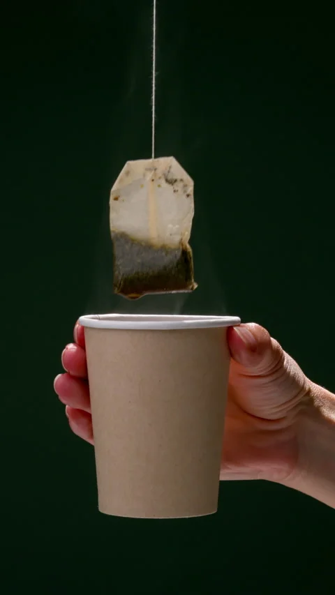 Tea in a paper cup. Tea bag. Video stock 310364139