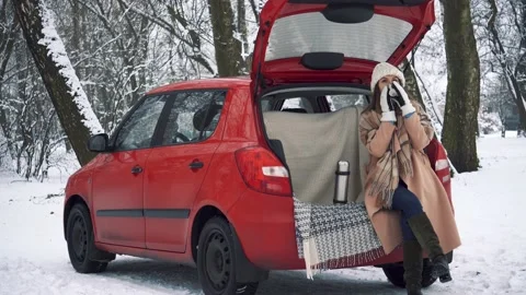 Tea party in car trunk - loving couple sits in car trunk Stock Footage 166745876