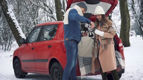Tea party in car trunk - loving couple sits in car trunk Stock Footage 166745877