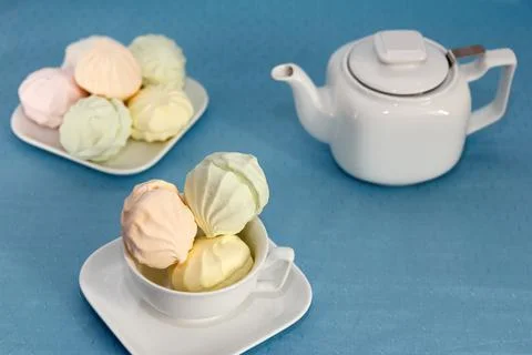 Tea party time. On a serviced table lies a stunning fresh marshmallow and a t Stock Photos