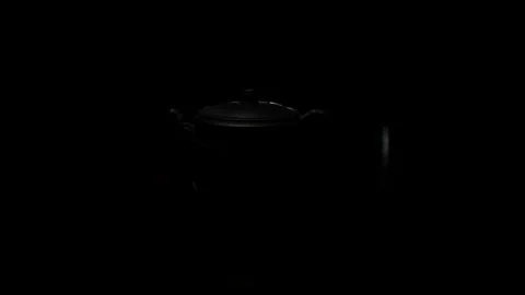 A tea-pot from expensive clay in a ray of light Stock Footage 107817659