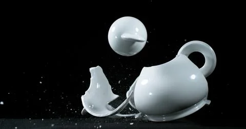Tea-Pot falling and exploding on Black Background 스톡 사진