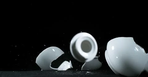 Tea-Pot falling and exploding on Black Background Foto stock