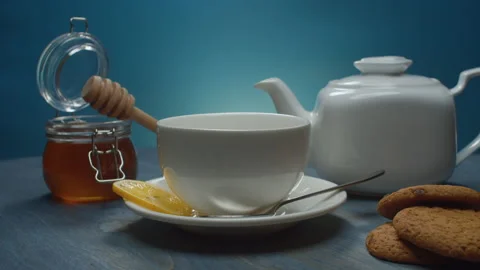 Tea pot, tea cup, honey and cookies Stock Footage 146273474