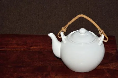 Tea pot on teak table Stock Photos