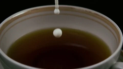 In tea pour milk and throw sugar. Slow mo Video stock 75811430