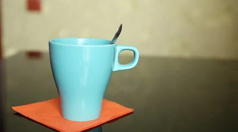 Tea is poured into a blue ceramic glass Stock Footage 60423249