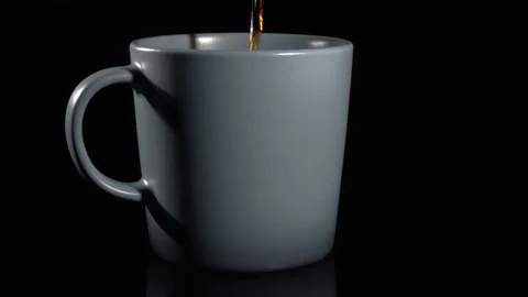 Tea is poured into the cup. On a black background. Stock Footage 147097789