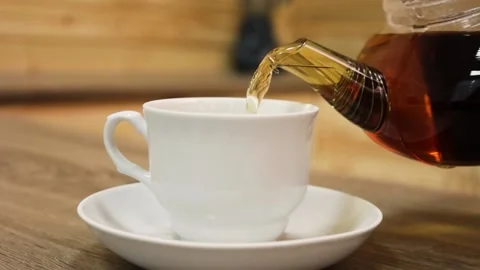 Tea is poured into a cup drink breakfast morning cafe table sugar teapot Stock Footage 168341970