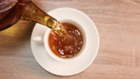 Tea is poured into a cup drink breakfast morning cafe table sugar teapot Stock Footage 168341972